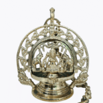 Traditional brass Gajalakshmi hanging vilakku with an intricately carved ornamental arch, Goddess Lakshmi seated at the centre, and a decorative hanging hook.